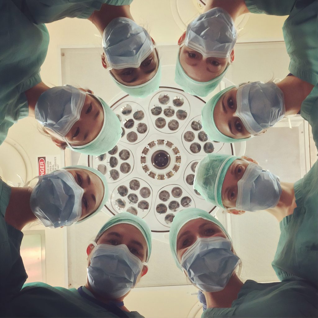 Doctors looking over a patient